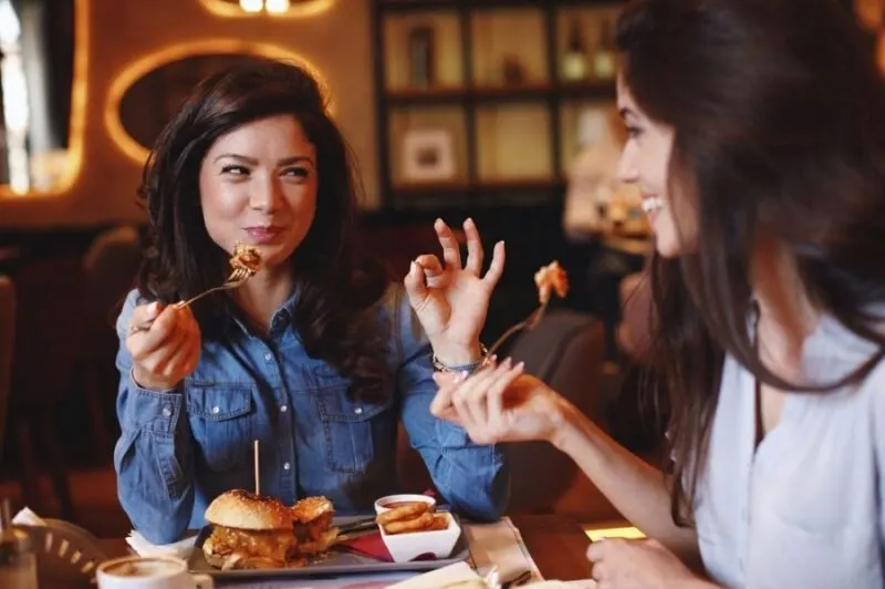 girls eating fries and burger